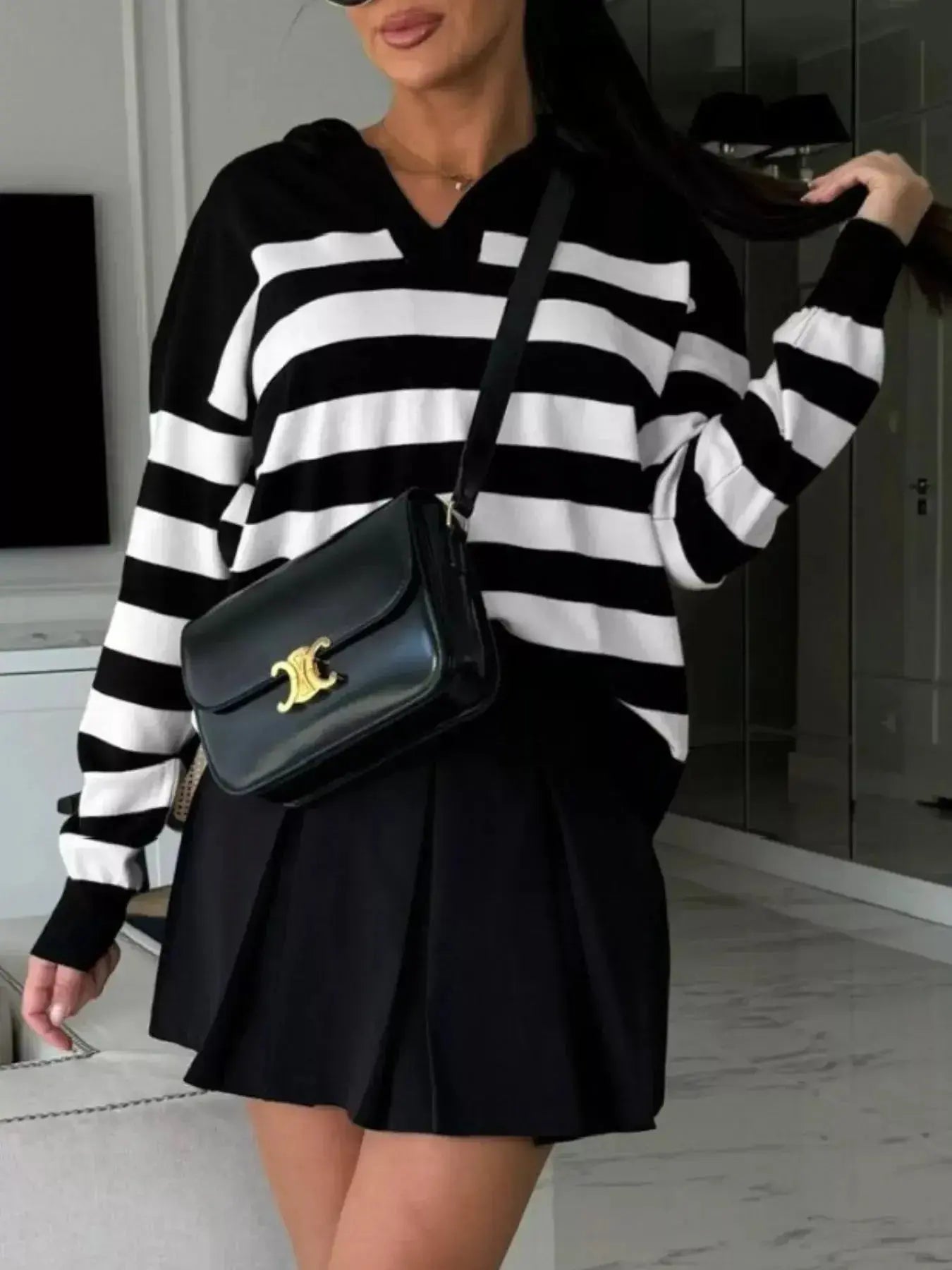 Women's striped dropped shoulder knit sweater top from Plush Fashion Hub, featuring long sleeves and a casual relaxed fit.
