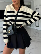Women's striped dropped shoulder knit sweater top with long sleeves from Plush Fashion Hub, casual and stylish for everyday wear.