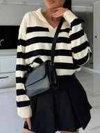 Women's striped dropped shoulder knit sweater top by Plush Fashion Hub, featuring casual long sleeves and relaxed fit.