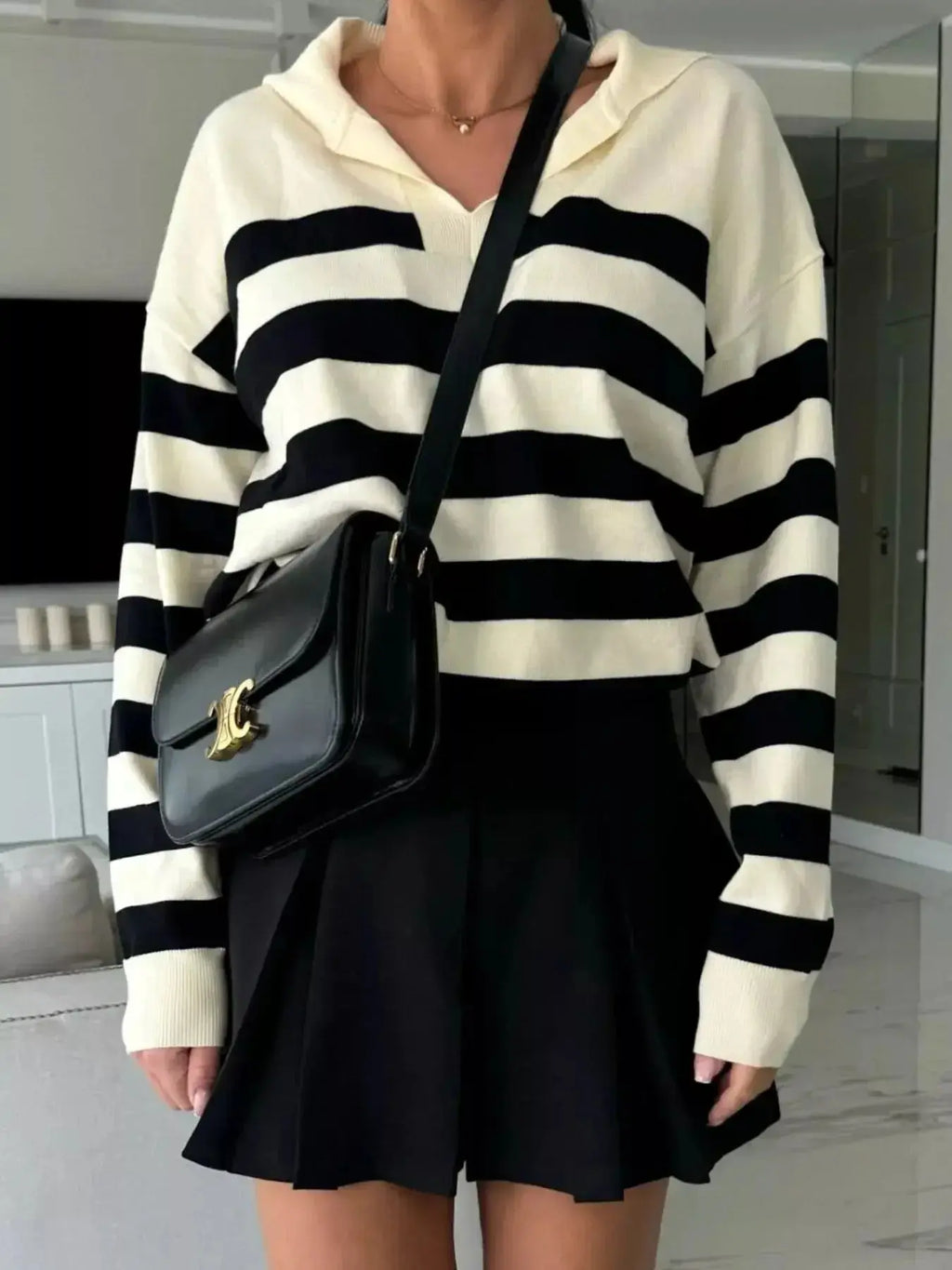 Women's striped dropped shoulder knit sweater top by Plush Fashion Hub, featuring casual long sleeves and relaxed fit.