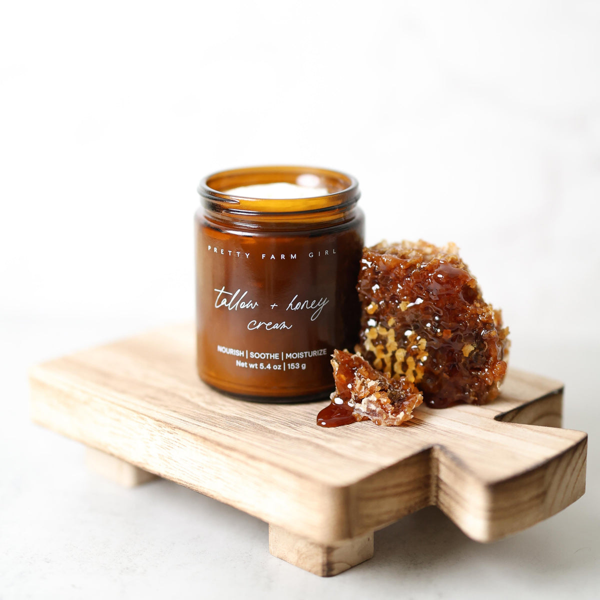 Fragrance-free tallow and honey cream for sensitive skin by Pretty Farm Girl, showing a jar of nourishing skincare cream.
