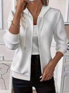 Women's textured zip-up hoodie with adjustable drawstring from Plush Fashion Hub, showcasing soft fabric and front zipper detail.