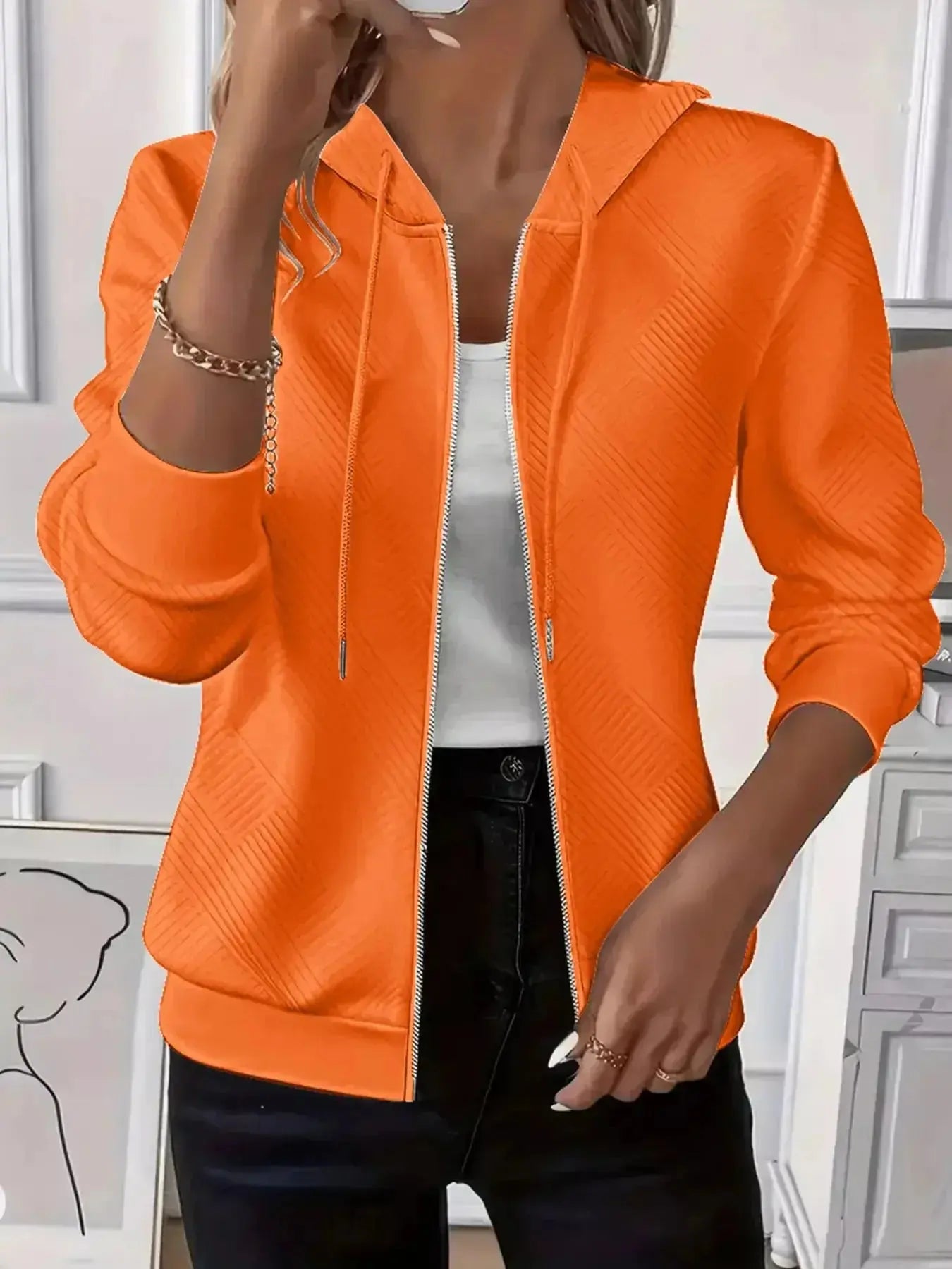 Women's textured zip-up hoodie with adjustable drawstring by Plush Fashion Hub, featuring a soft, cozy material and stylish design.