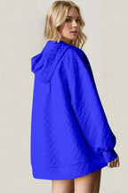 Textured drop shoulder long sleeve hoodie sweater from Plush Fashion Hub by Trendsi, showcasing a cozy, stylish design.