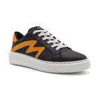 Black and gold two-tone low-top sneakers by BLKSWN Footwear shown from an angled view.