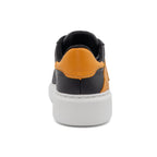 Black and gold two-tone lowtop sneaker by BLKSWN Footwear, showing the back view of the stylish design.