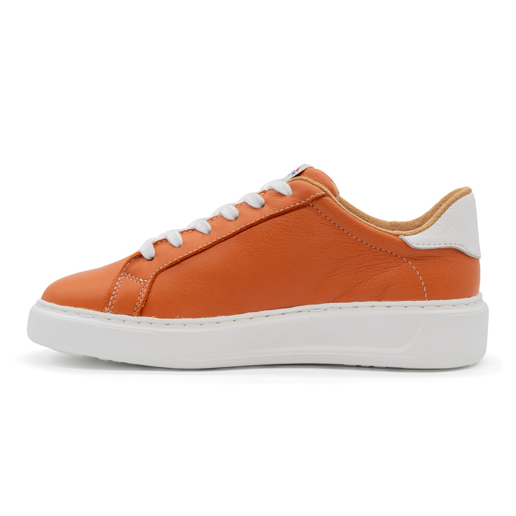 Burnt orange and white low-top sneakers from BLKSWN Footwear with a two-tone design, shown from the left side.