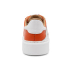 BLKSWN Footwear 601 two-tone lowtop sneakers in orange and white, showing the back view with contrasting color accents.