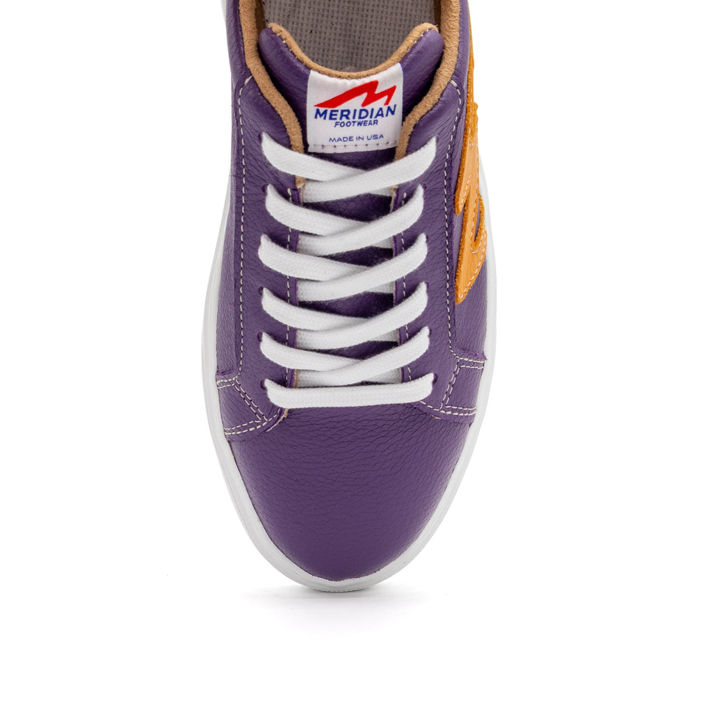 BLKSWN Footwear 601 lowtop sneakers in two-tone purple and gold with a sleek, stylish design.