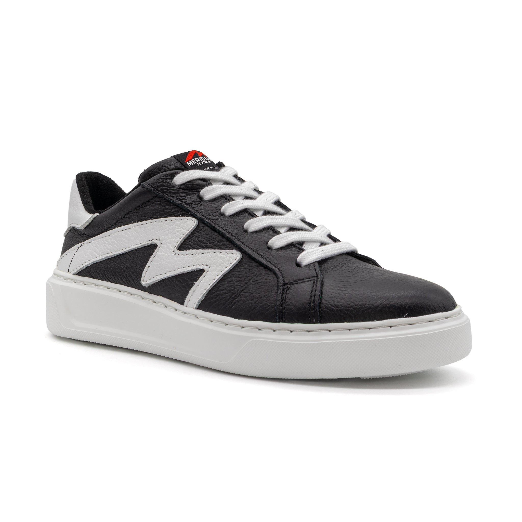 Black and white two-tone lowtop sneakers by BLKSWN Footwear, angled view showcasing stylish casual footwear design.