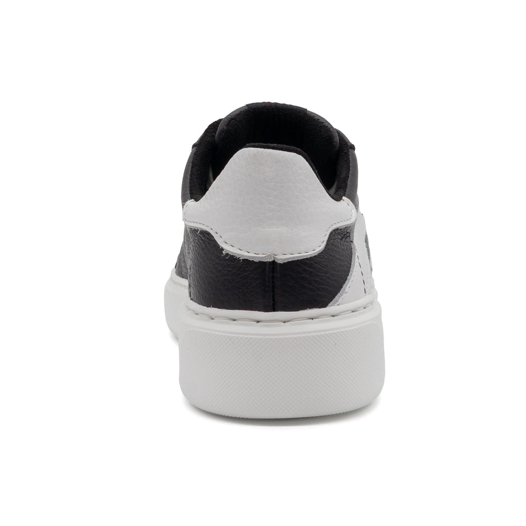 Black and white two-tone lowtop sneakers by BLKSWN Footwear shown from the back view.