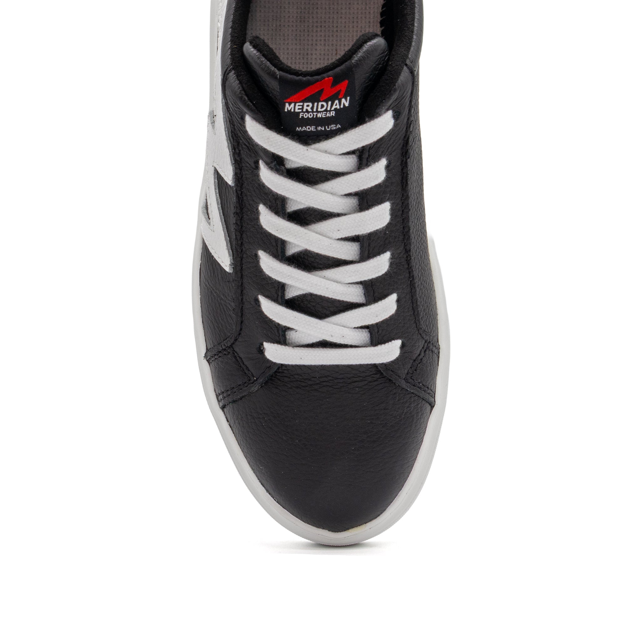 Black and white two-tone lowtop sneakers by BLKSWN Footwear, featuring a stylish contrast design and classic silhouette.