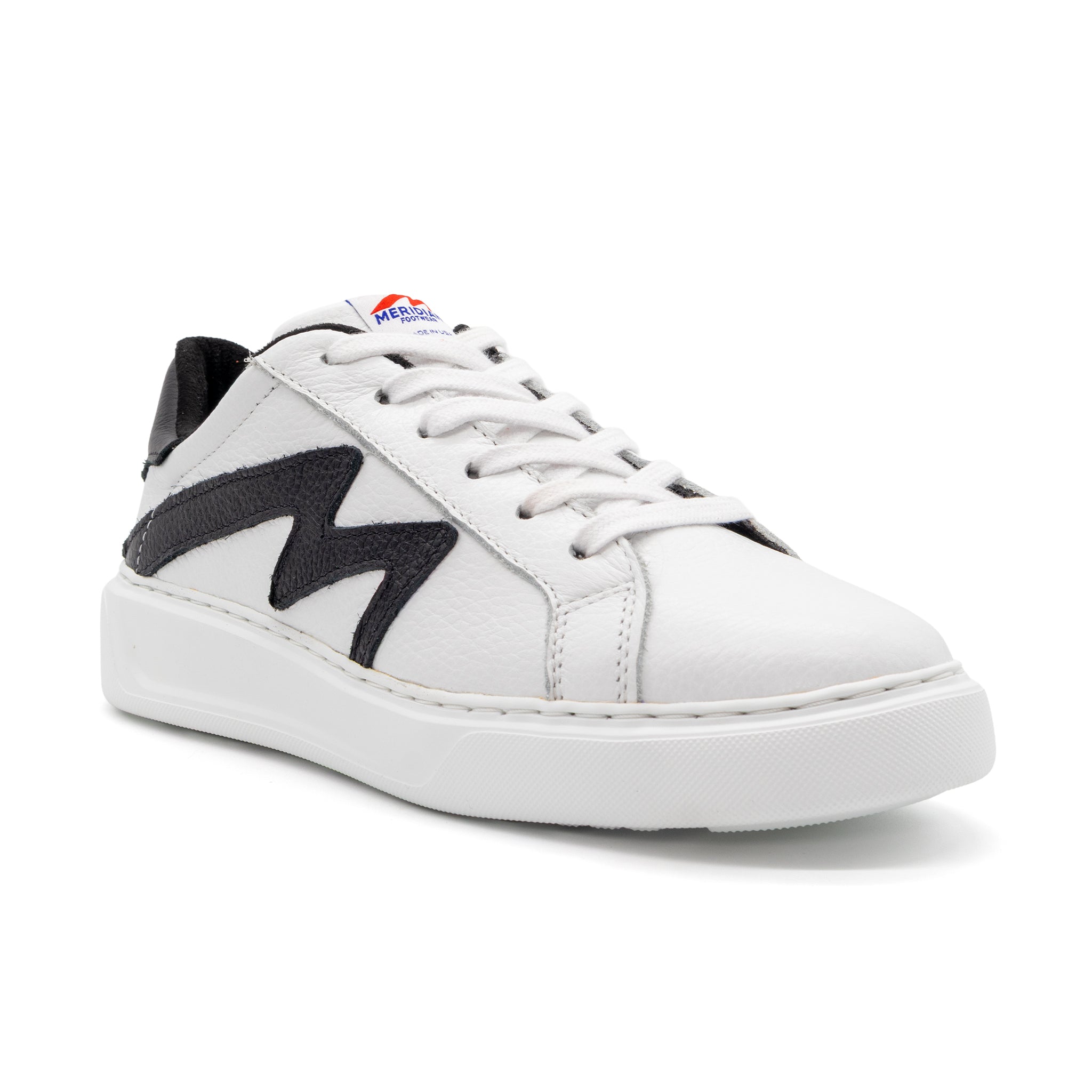 Black and white two-tone lowtop sneakers by BLKSWN Footwear, angled view showcasing stylish design and contrasting colors.
