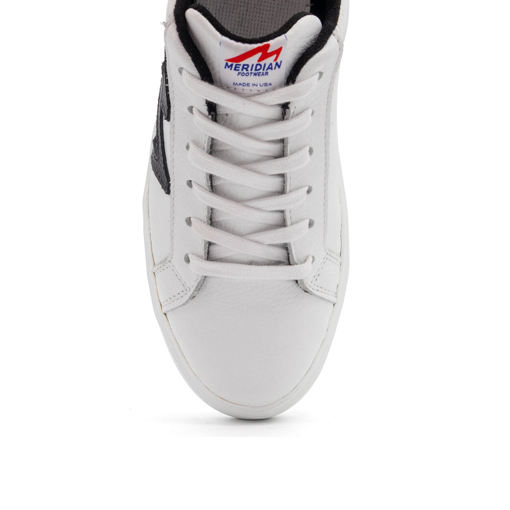 Black and white two-tone lowtop sneakers by BLKSWN Footwear with sleek design and contrasting color accents.