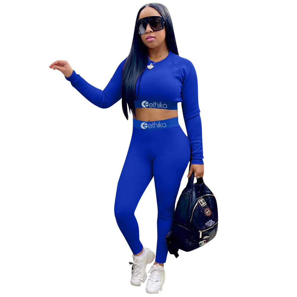 Women's two-piece sports set with letter print by Trendy Attic Store01, featuring a fitted top and matching leggings.