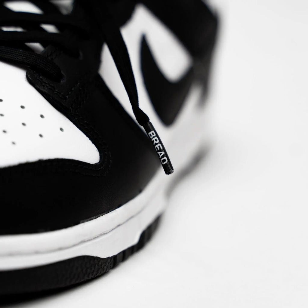 Black elastic shoelaces from Plush Fashion Hub, showing a close-up of the stretchy, durable cords suitable for sneakers and casual shoes.