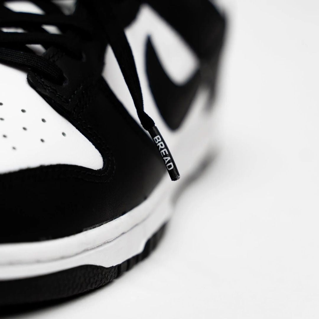 Black elastic shoelaces from Plush Fashion Hub, showing a close-up of the stretchy, durable cords suitable for sneakers and casual shoes.