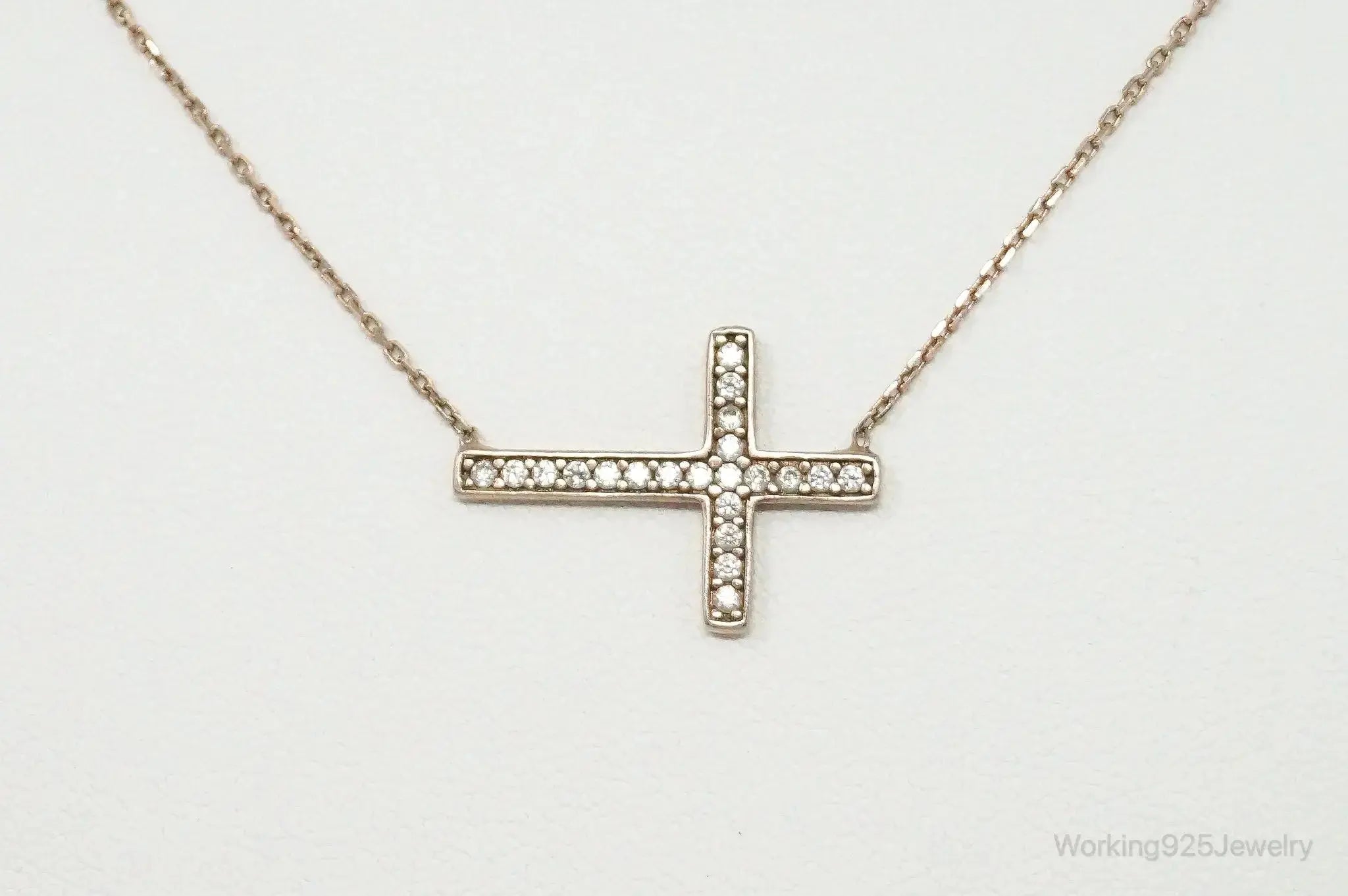 Vintage cubic zirconia rose gold vermeil sterling silver cross necklace, jewelry pendant with sparkling stones and intricate design.