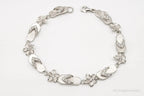 Vintage cubic zirconia sandals and flowers sterling silver bracelet, jewelry accessories with intricate details and elegant design.