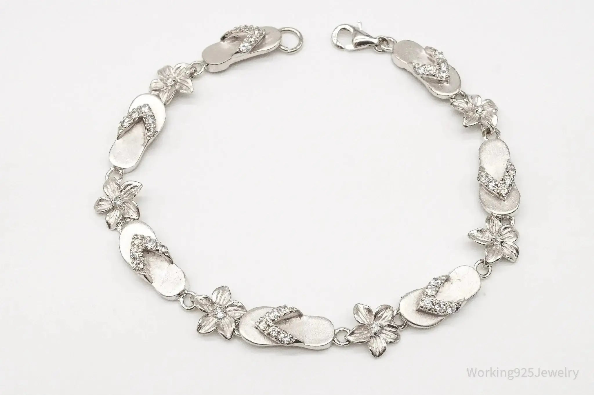 Vintage cubic zirconia sandals and flowers sterling silver bracelet, jewelry accessories with intricate details and elegant design.