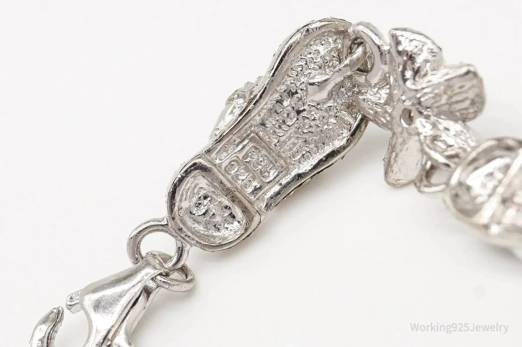 Vintage cubic zirconia sandals and flower sterling silver bracelet, elegant jewelry set showcasing intricate design details.