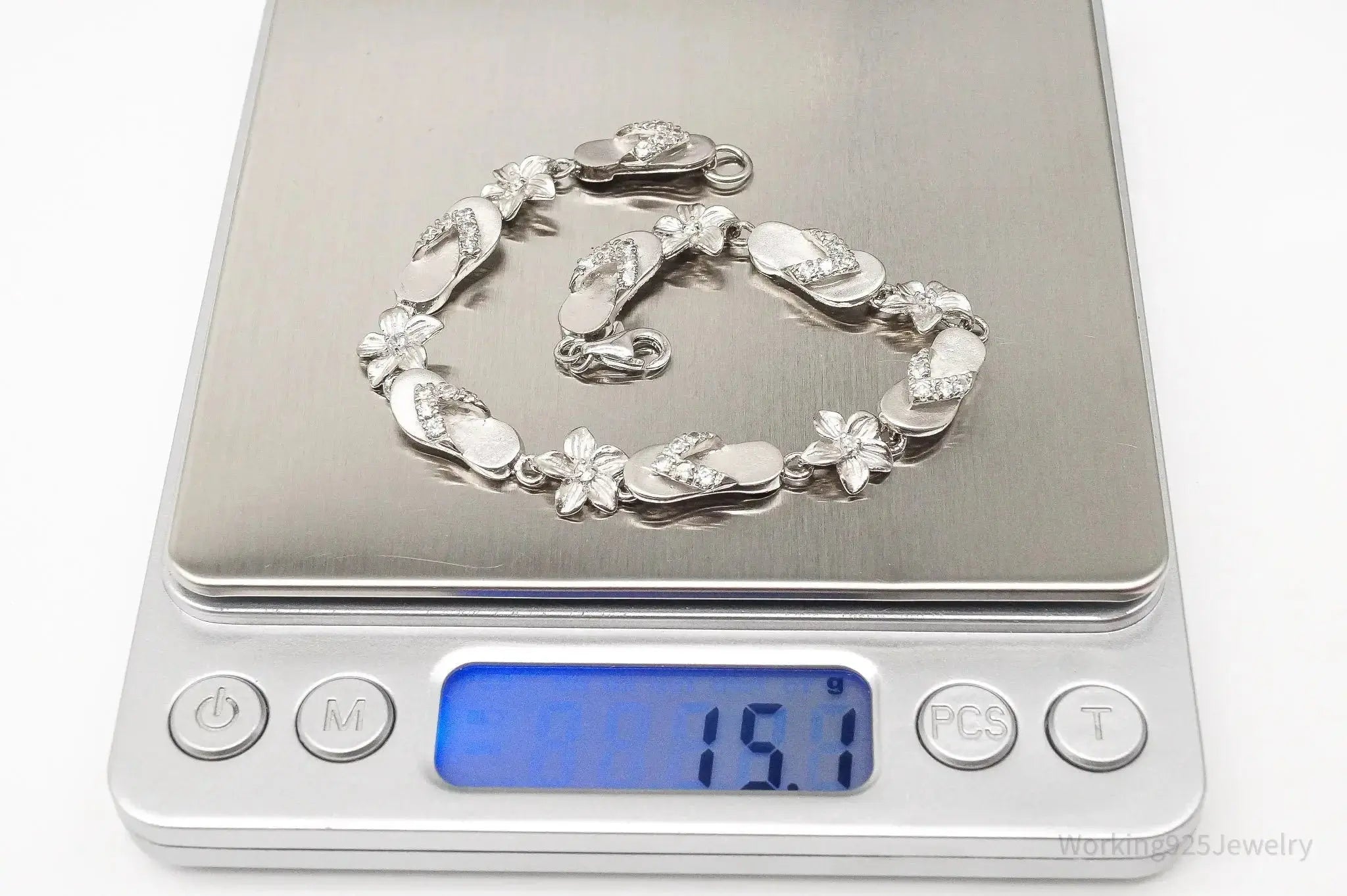 Vintage cubic zirconia sandals and flowers sterling silver bracelet, elegant jewelry set with detailed silver and sparkling stones.