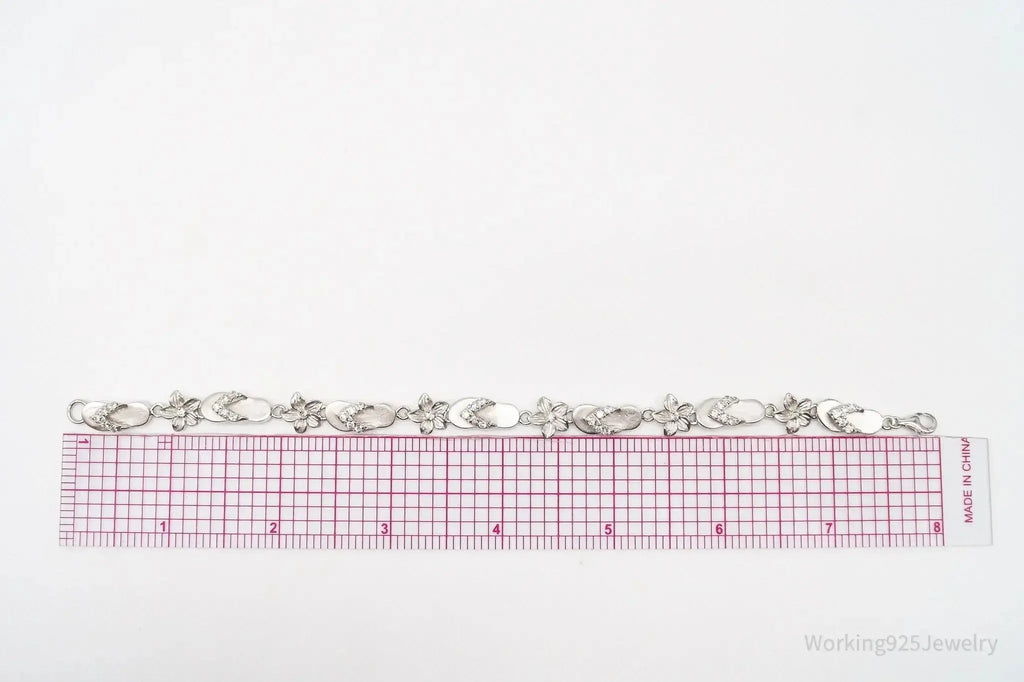 Vintage Sterling Silver Bracelet with floral and cubic zirconia accents, showcasing intricate jewelry design.