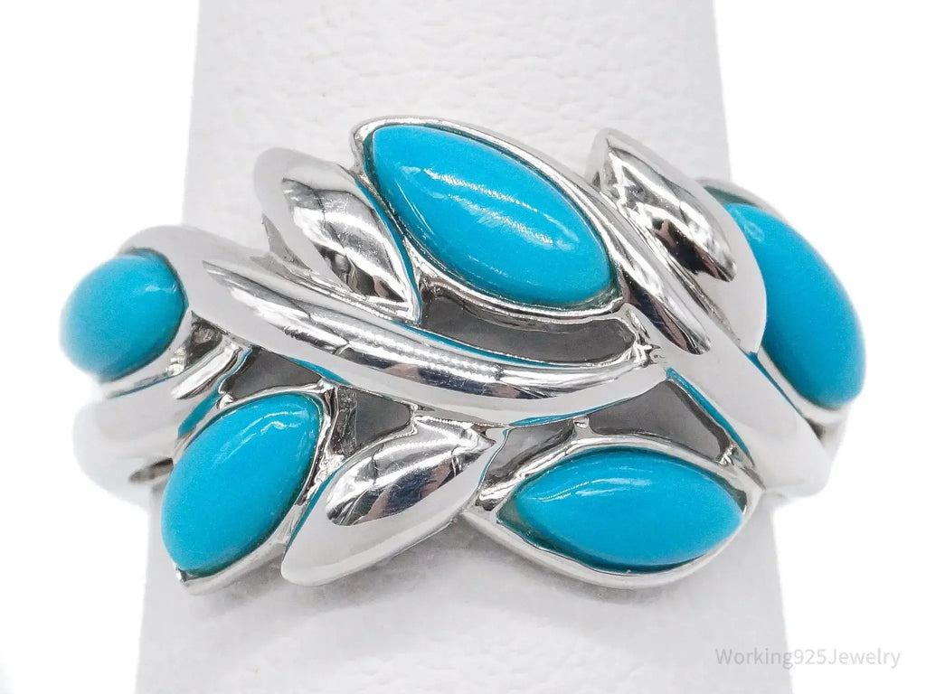 Vintage designer EA turquoise sterling silver ring, size 5, featuring a detailed jewelry design with vibrant turquoise stone.