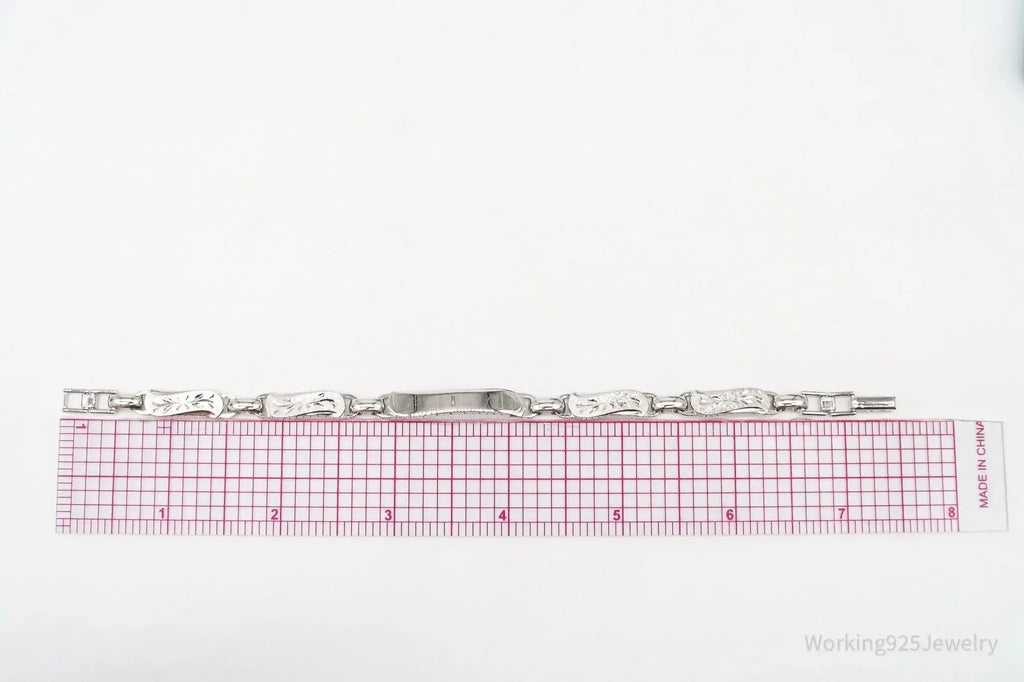 Vintage LaMode sterling silver ID bar bracelet with engraved name tag, stylish jewelry piece by Plush Fashion Hub.