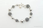 Vintage Michael Dawkins sterling silver bracelet with pearl-spotted ball design, elegant jewelry piece.
