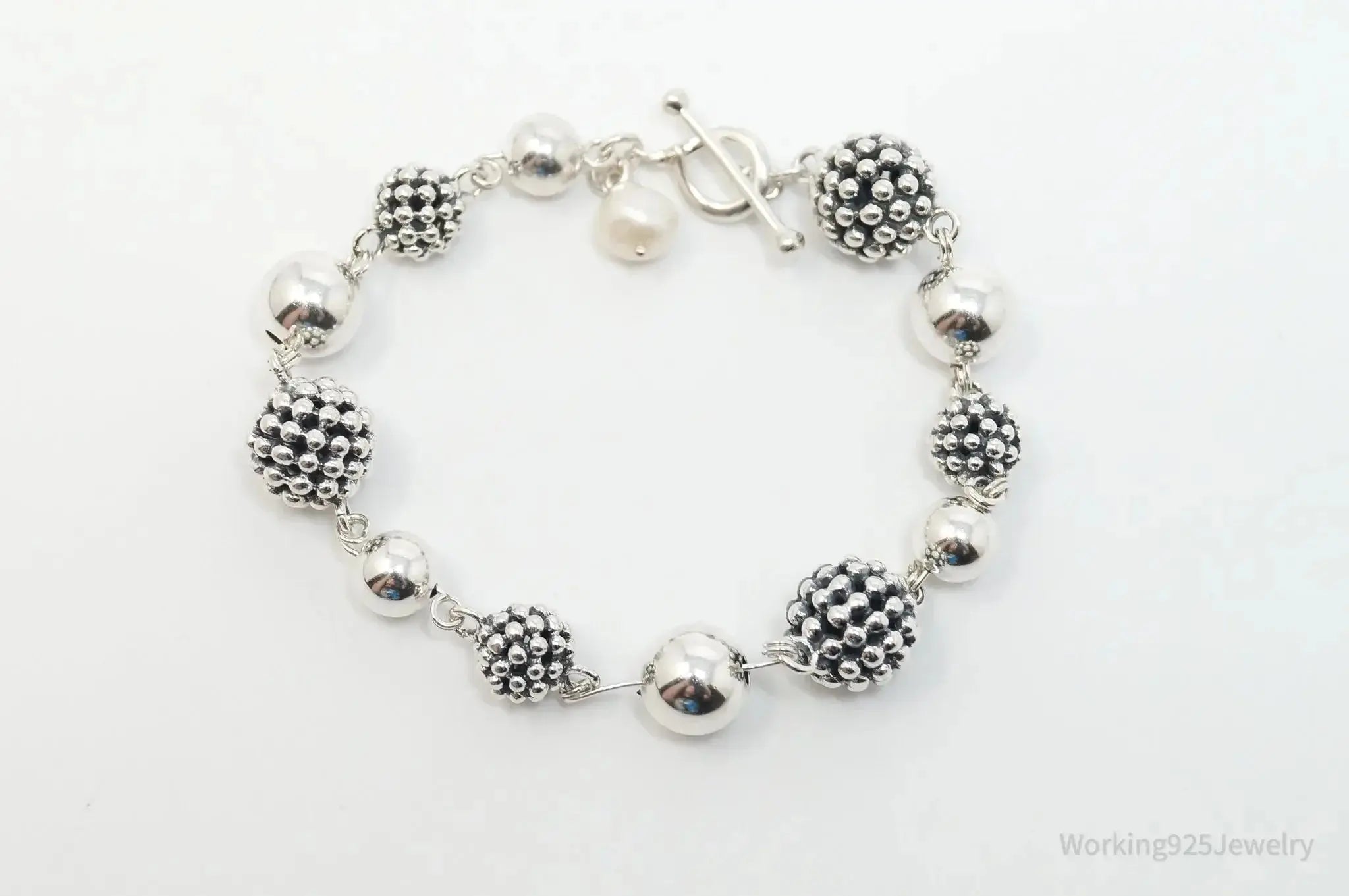 Vintage Michael Dawkins sterling silver bracelet with pearl-spotted ball design, elegant jewelry piece.