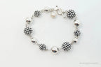 Vintage Michael Dawkins sterling silver bracelet with pearl-spotted ball design, elegant jewelry piece featuring intricate craftsmanship.