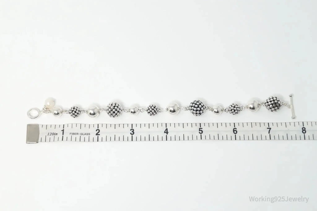 Vintage Michael Dawkins sterling silver bracelet with pearl-spotted ball design, crafted for elegant jewelry style.
