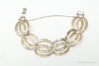 Vintage designer sterling silver bracelet with 14K gold accents, featuring art deco symmetrical design.
