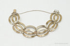 Vintage designer silver bracelet with 14K gold accents featuring Art Deco style, crafted by Plush Fashion Hub.