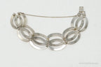Vintage designer sterling silver bracelet with 14K gold accents, featuring art deco symmetalic design, by Plush Fashion Hub.