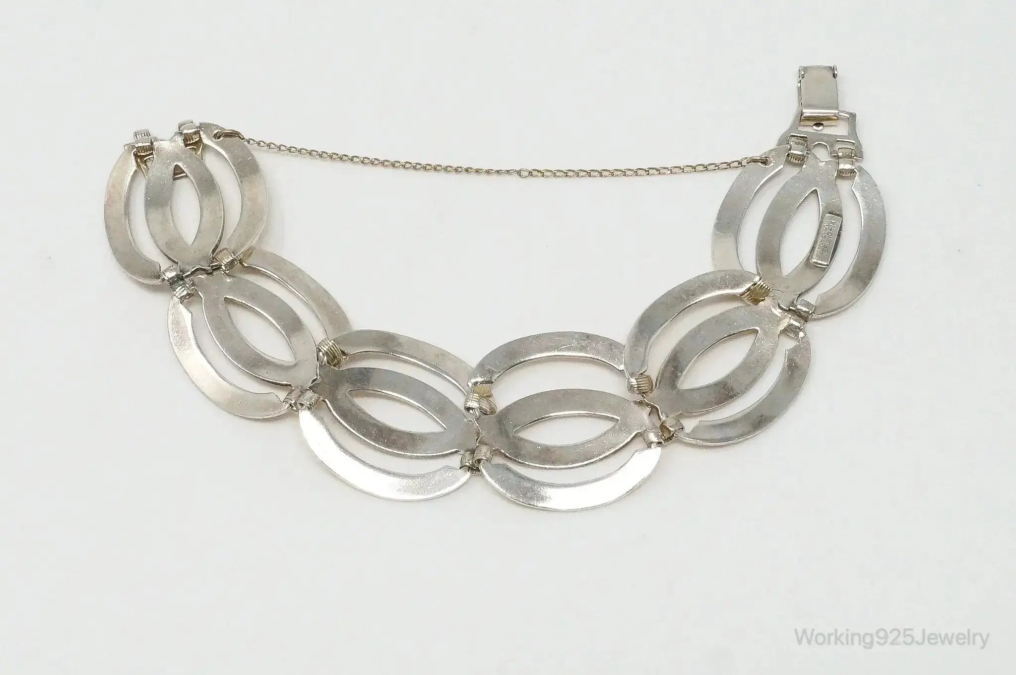 Vintage designer sterling silver bracelet with 14K gold accents, featuring art deco symmetalic design, by Plush Fashion Hub.