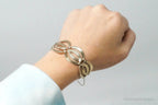 Vintage designer silver bracelet with 14K gold accents, featuring Art Deco style, sterling silver jewelry by Plush Fashion Hub.