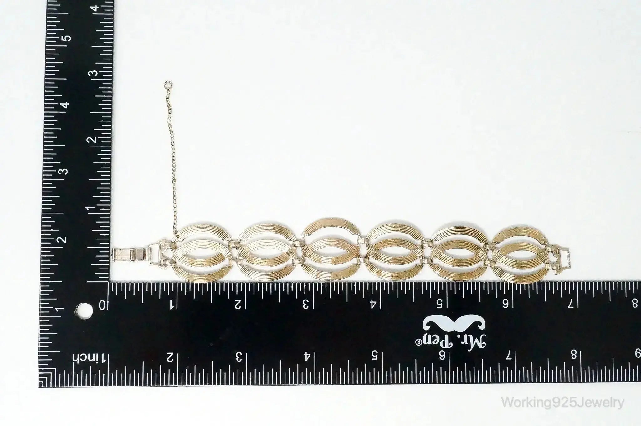 Vintage designer sterling silver bracelet with gold accents, art deco style, from Plush Fashion Hub, showcasing intricate metalwork.