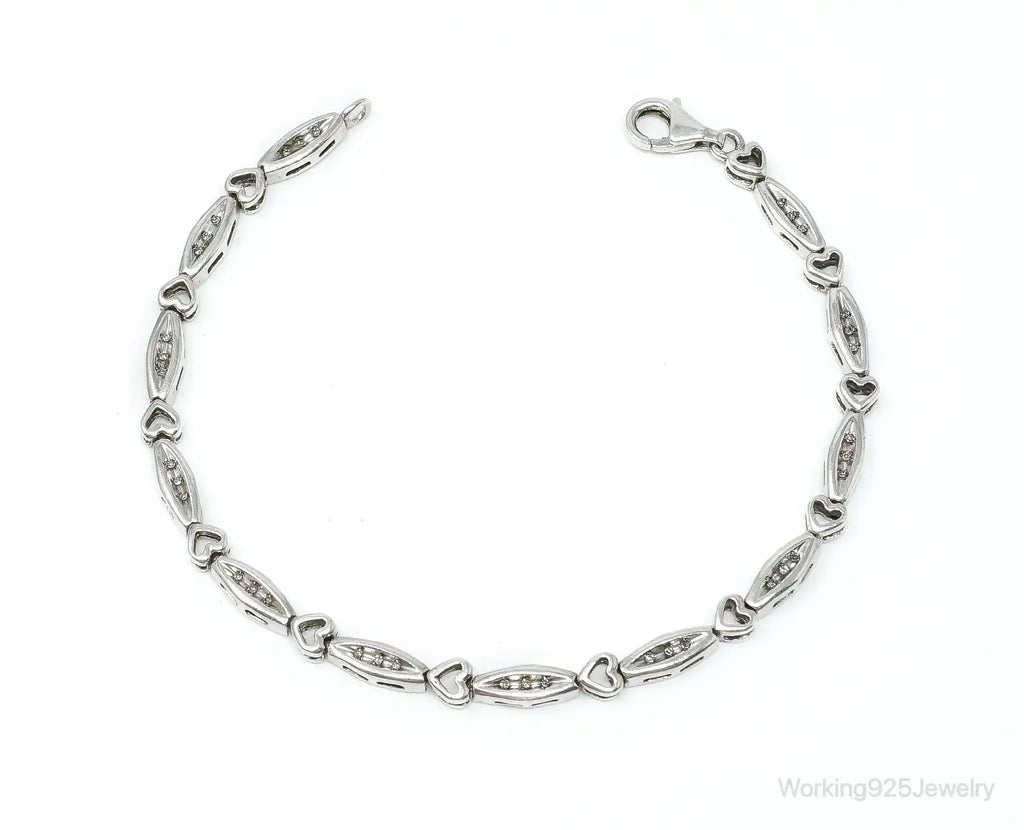 Vintage diamond-linked hearts sterling silver bracelet from Plush Fashion Hub, showcasing intricate heart-shaped charms and shiny silver links.