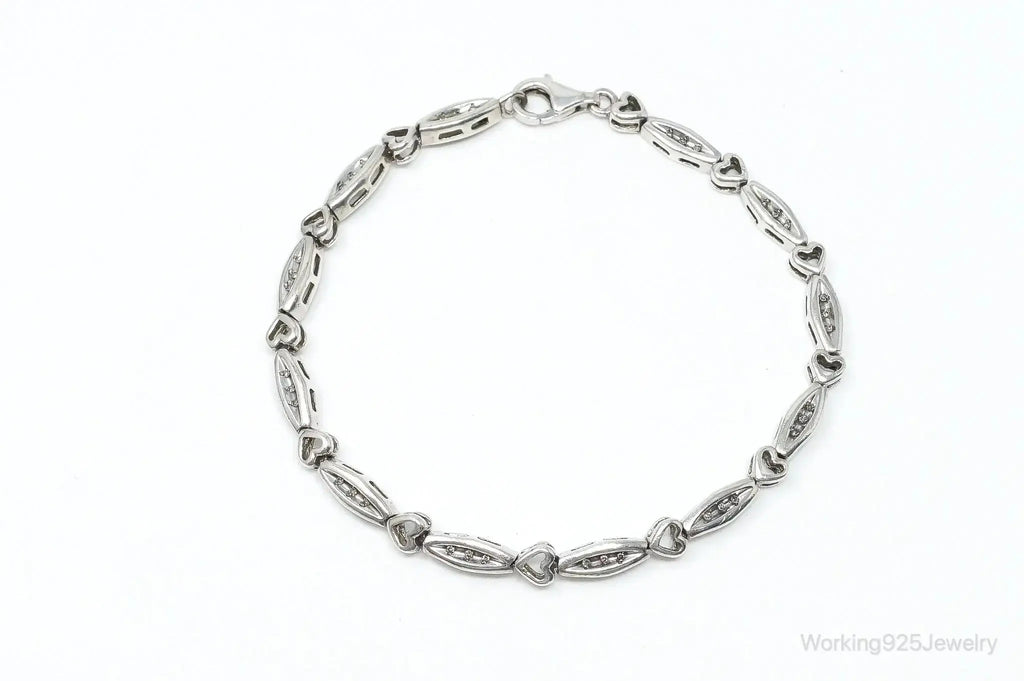 Sterling silver bracelet with vintage diamond-linked heart charms, elegant jewelry from Plush Fashion Hub