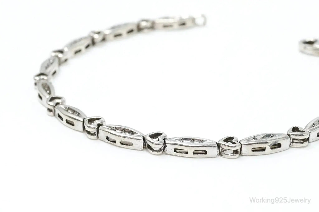 Sterling silver bracelet with vintage diamond-linked heart charms, elegant jewelry piece from Plush Fashion Hub.