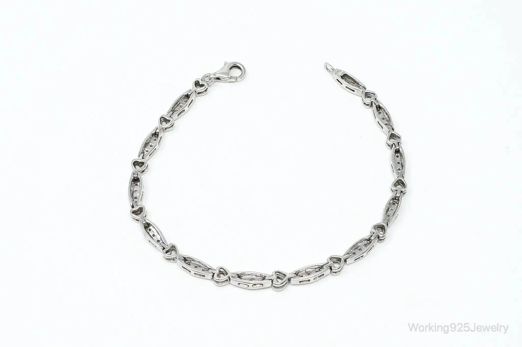 Sterling silver bracelet with vintage diamond-linked heart charms, crafted by Plush Fashion Hub.
