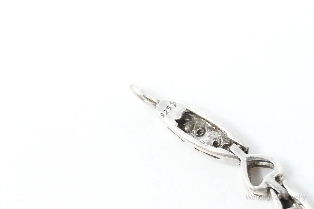 Vintage sterling silver bracelet with linked heart and diamond-shaped charms, elegant jewelry design by Plush Fashion Hub.