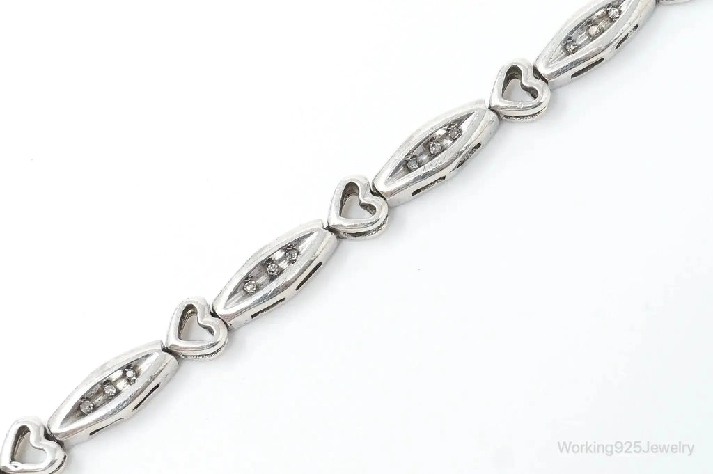 Sterling silver bracelet with vintage diamond-linked heart charms, elegant jewelry piece from Plush Fashion Hub