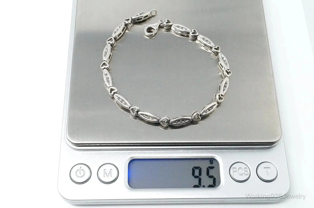 Vintage diamond-linked hearts sterling silver bracelet with intricate heart designs, stylish jewelry by Plush Fashion Hub