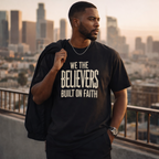 Black Christian T-shirt by Wear Your Worship featuring "We The Believers" text and faith-themed graphic design.