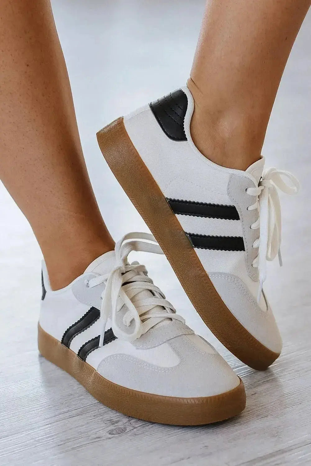 Women's white striped lace-up sneakers by Gilded Glamour Shop, casual flat shoes ideal for everyday comfort and walking.