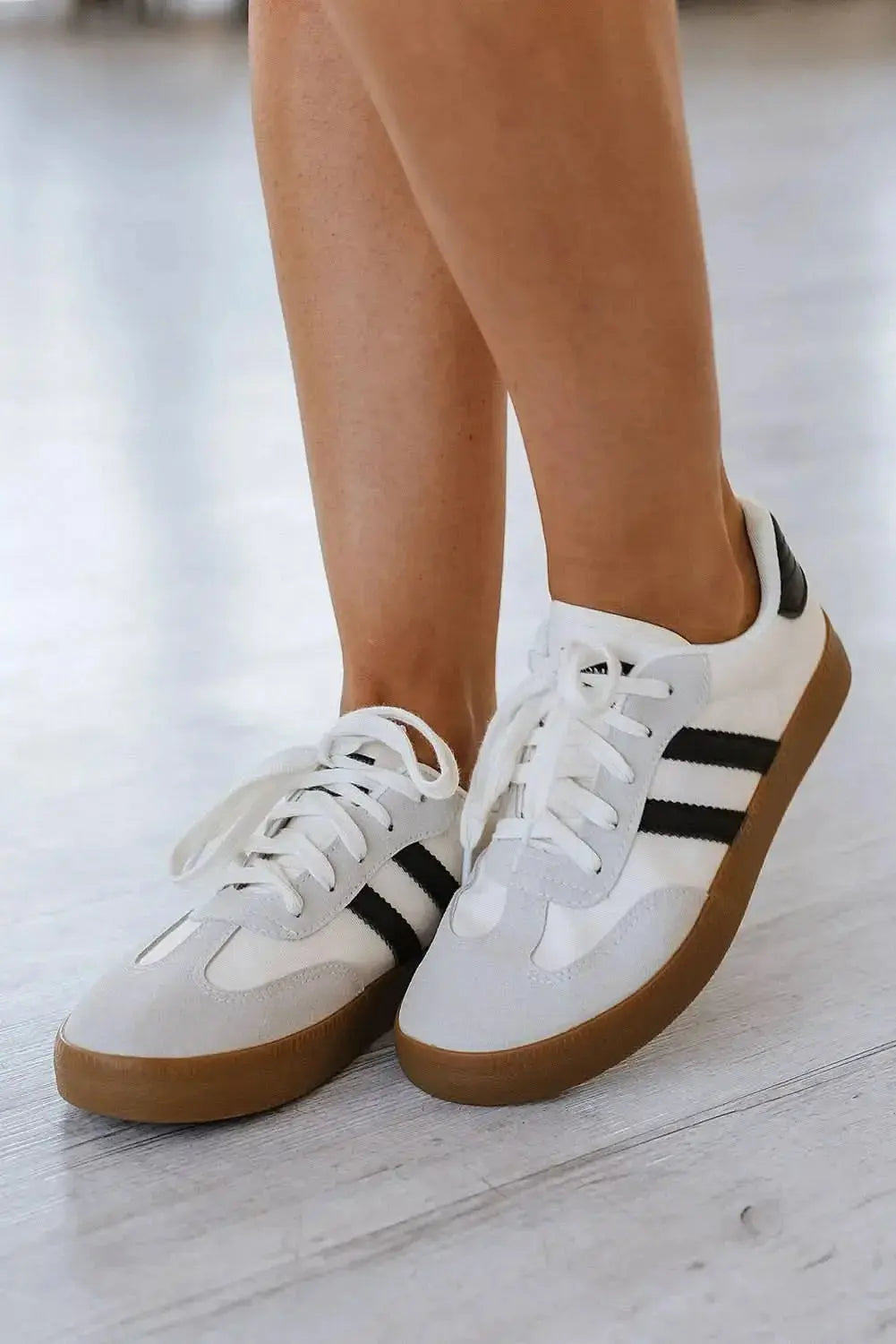 Women's white striped lace-up sneakers by Gilded Glamour Shop, featuring a casual flat design for comfortable everyday walking.