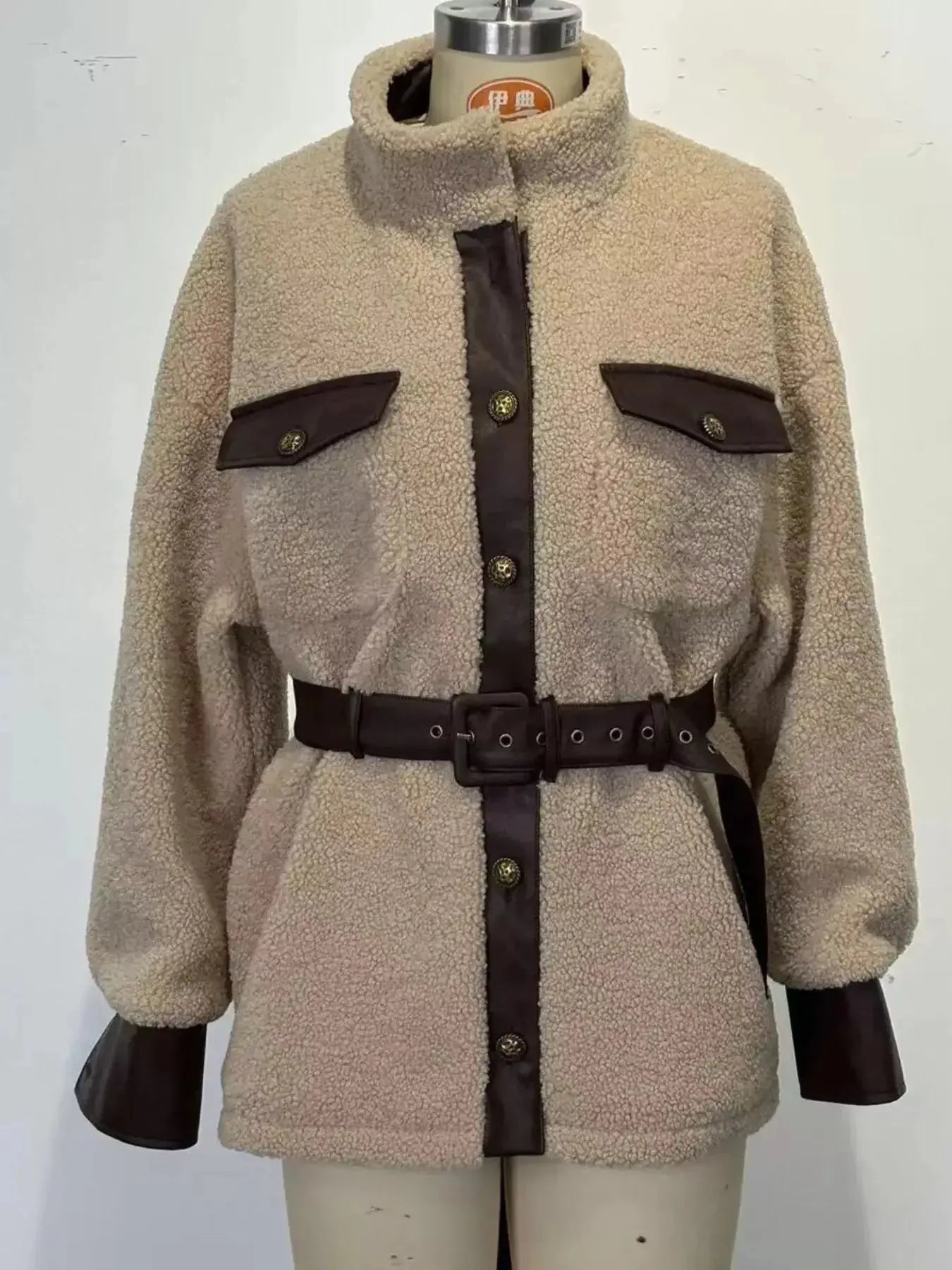 Women’s belted sherpa jacket with leather trim, featuring plush fabric and stylish design from Trendsi.
